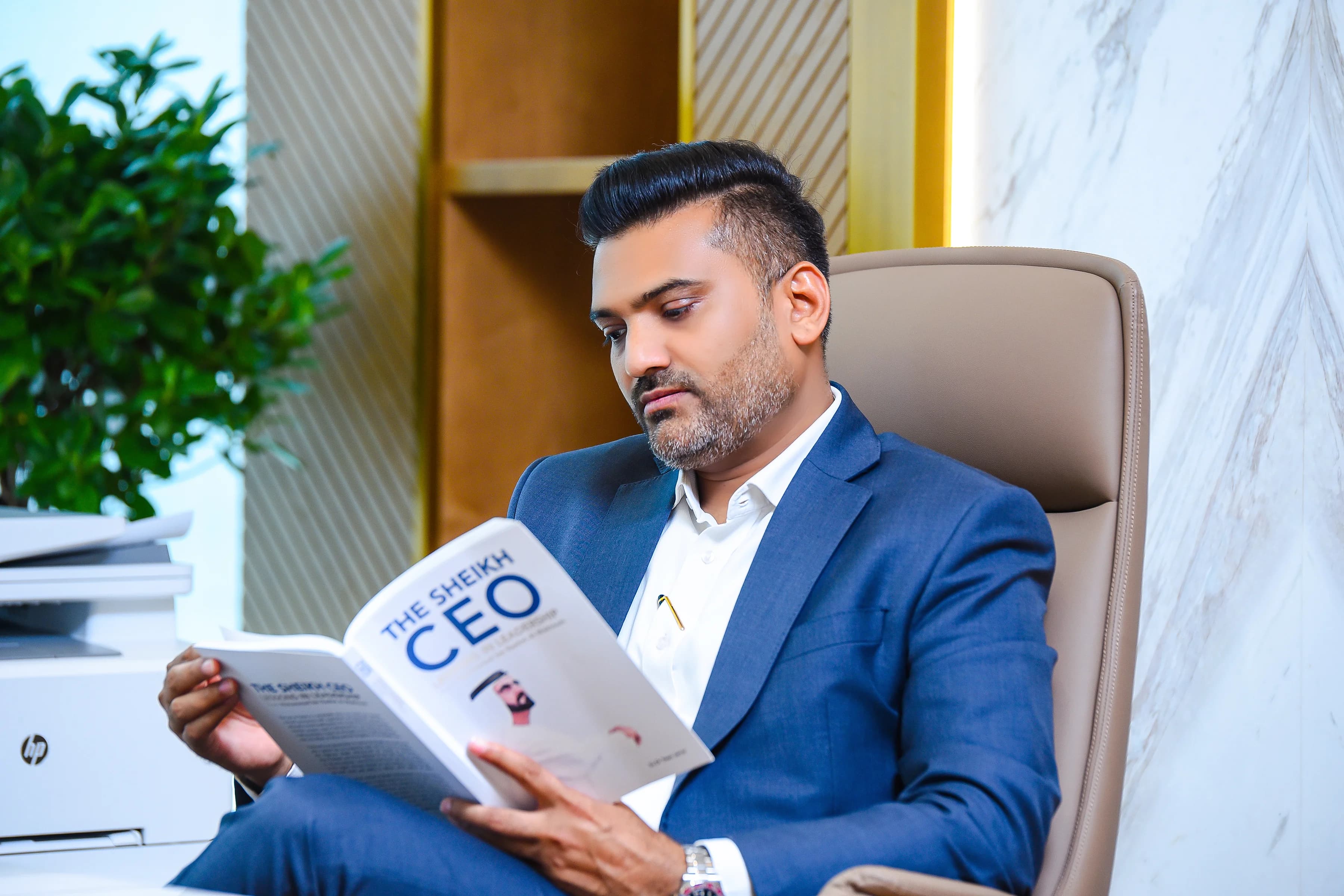 Jashvantkumar Prajapati reading at his Dubai office desk